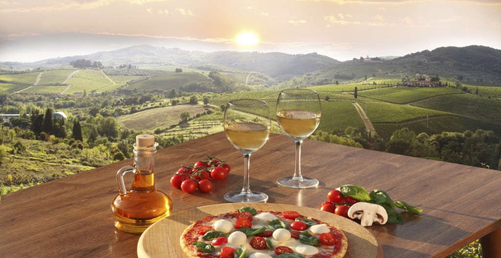 Chianti vineyards with pizza and glasses of white vine, Italy